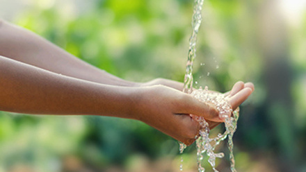 water running over cupped hands