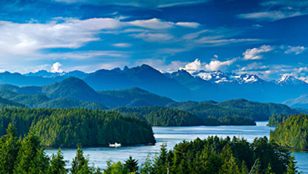waterway with islands, green forests and mountains in British Columbia