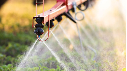 Close up of farm equipment spraying crops