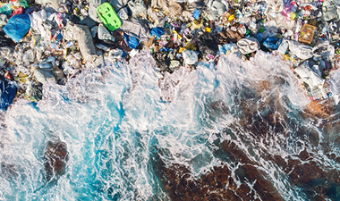 ocean cliff with plastic on shore