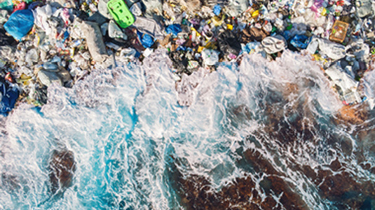 ocean cliff with plastic on shore