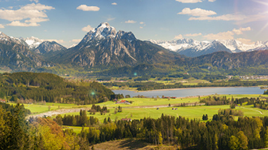 landscape with snow-capped mountains and blue lake