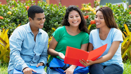 Students sitting on a wall discussing work