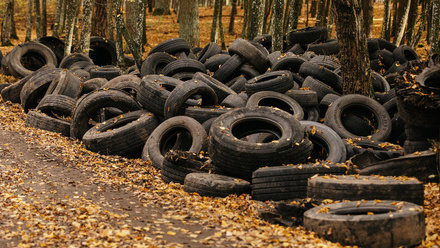 old tires thrown in a forest