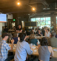 People sit at tables in a bar
