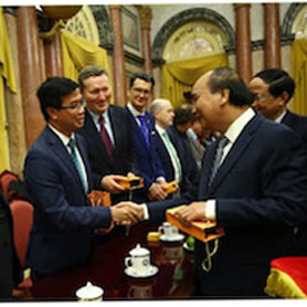 president of Vietnam shakes hands with scientists