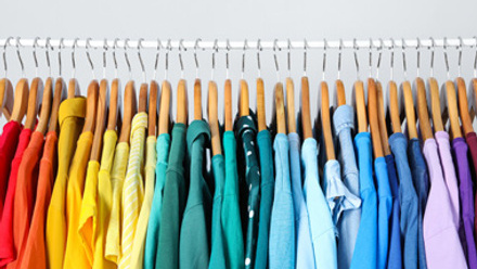 rack with clothes in rainbow colors