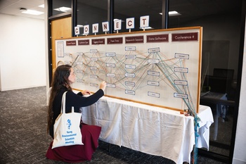 Student in front of the interactive display board that visually demonstrated shared connections among distinct personal preferences during YES